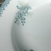 Set of three iron earthenware plates from the St Amandinoise earthenware factory, lily of the valley model.