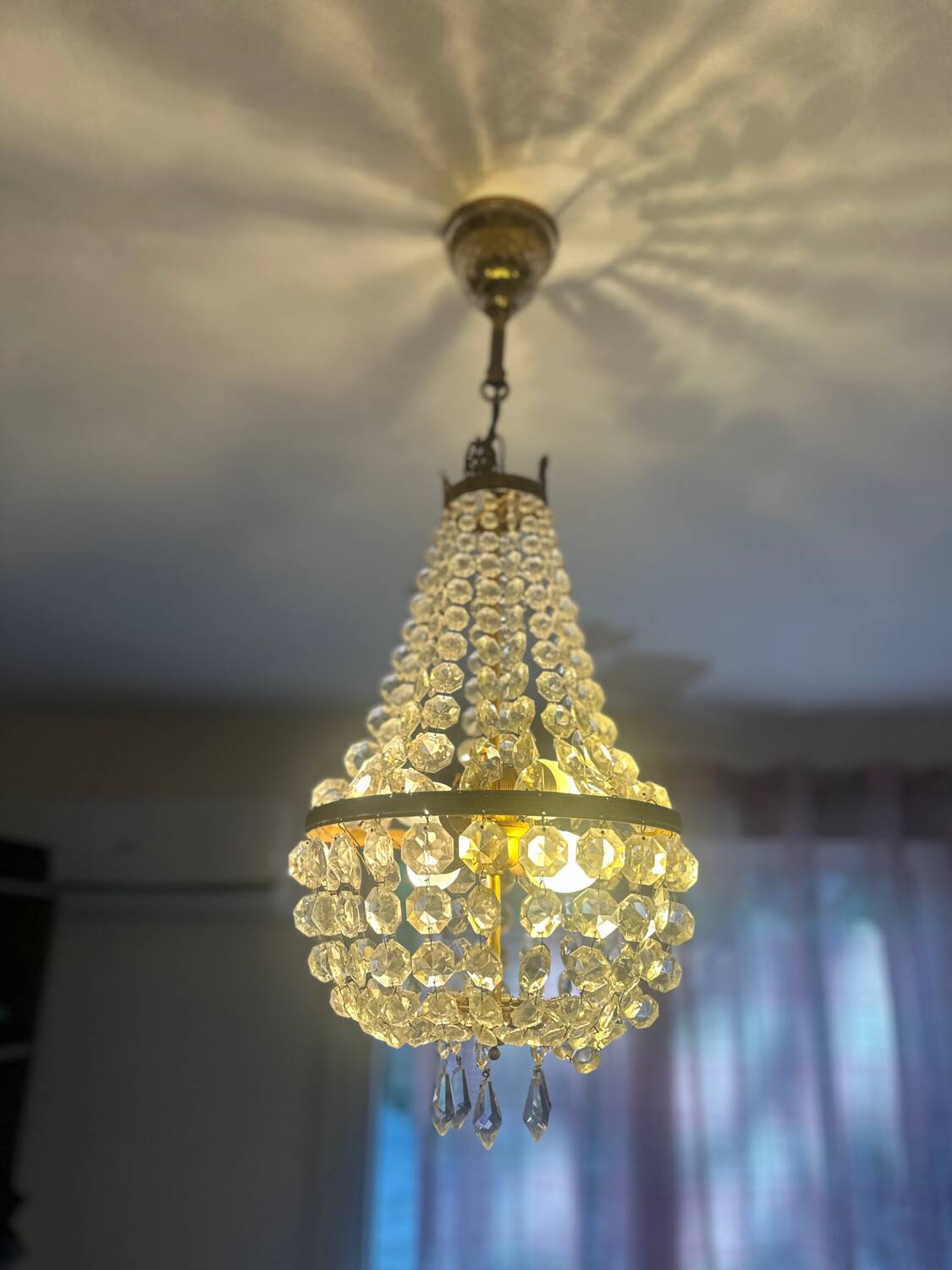 Basket chandelier with crystal and gilded brass pendants, circa 1930.
