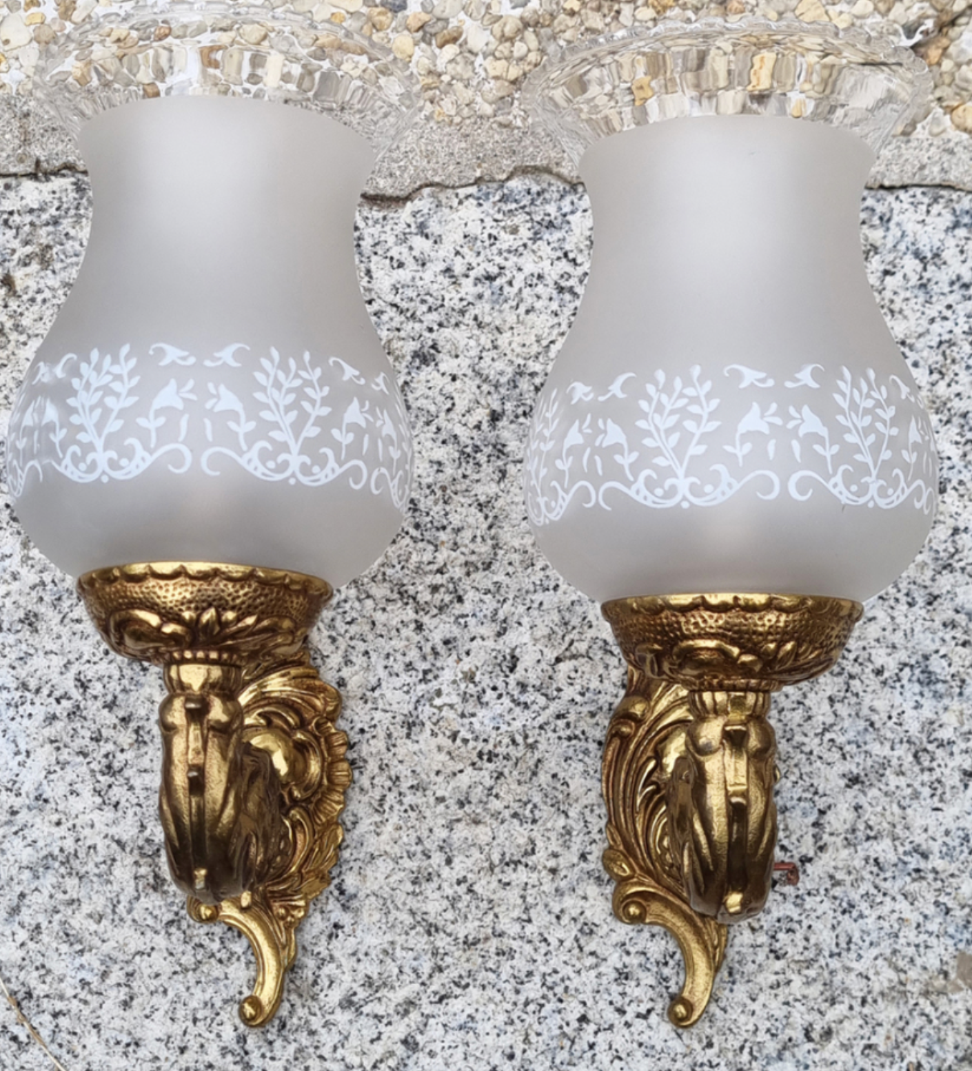 Pair of bronze wall lamps and frosted glass globe, early twentieth century.