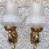 Pair of bronze wall lamps and frosted glass globe, early twentieth century.