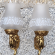 Pair of bronze wall lamps and frosted glass globe, early twentieth century.