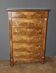 Empire-style walnut seven-drawer chest from the 19th century.