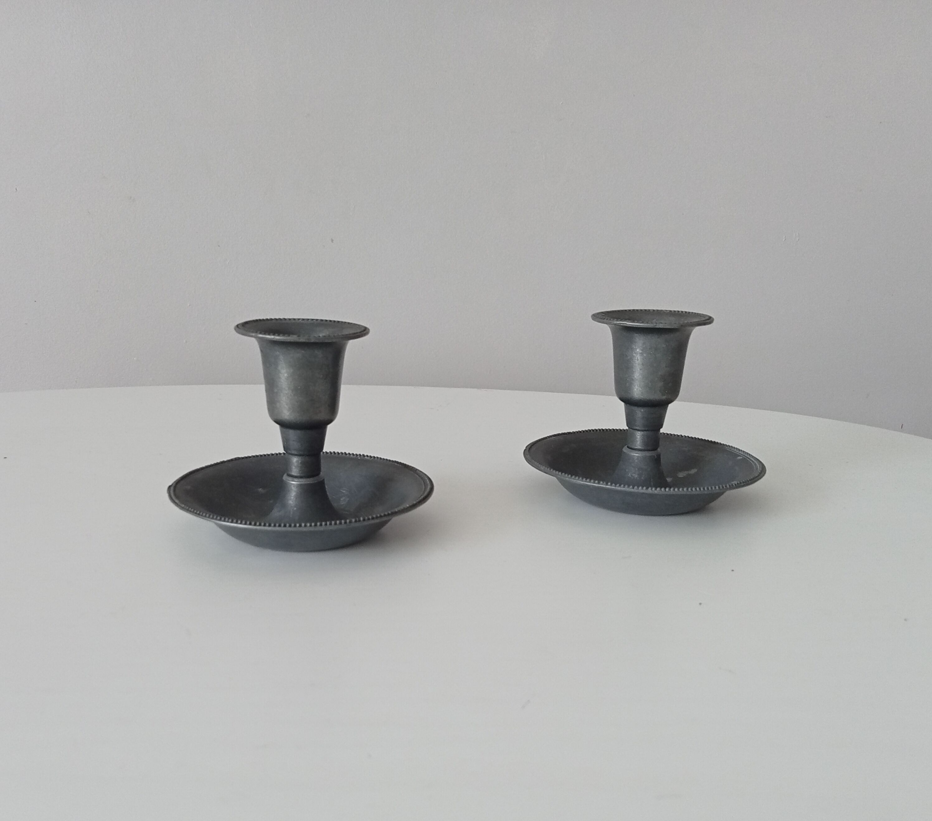Pair of antique pewter candle holders