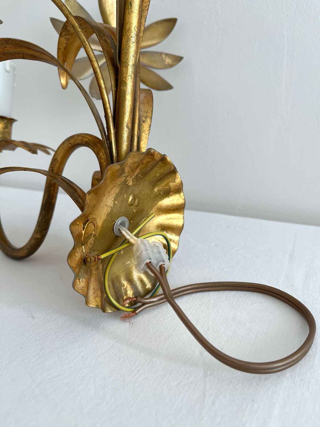 Vintage Hollywood Regency gold metal leaf wall sconce.
