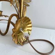 Vintage Hollywood Regency gold metal leaf wall sconce.