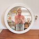 Large vintage round mirror with a white border.