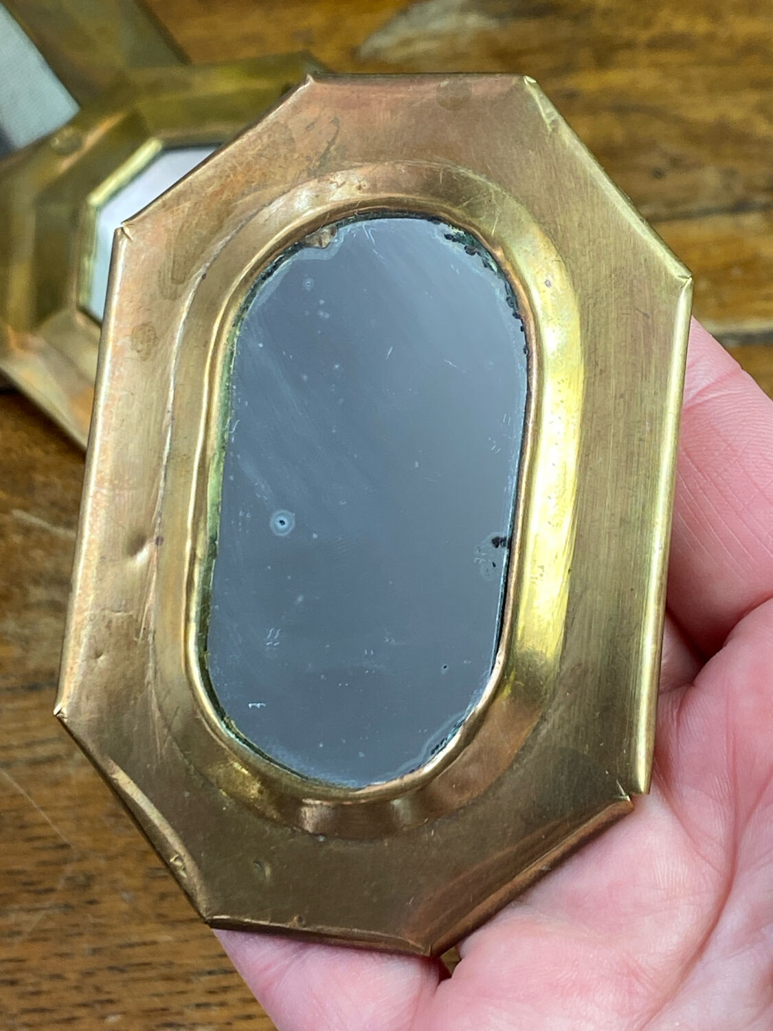 Set of five small wall mirrors in brass.