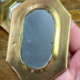 Set of five small wall mirrors in brass.