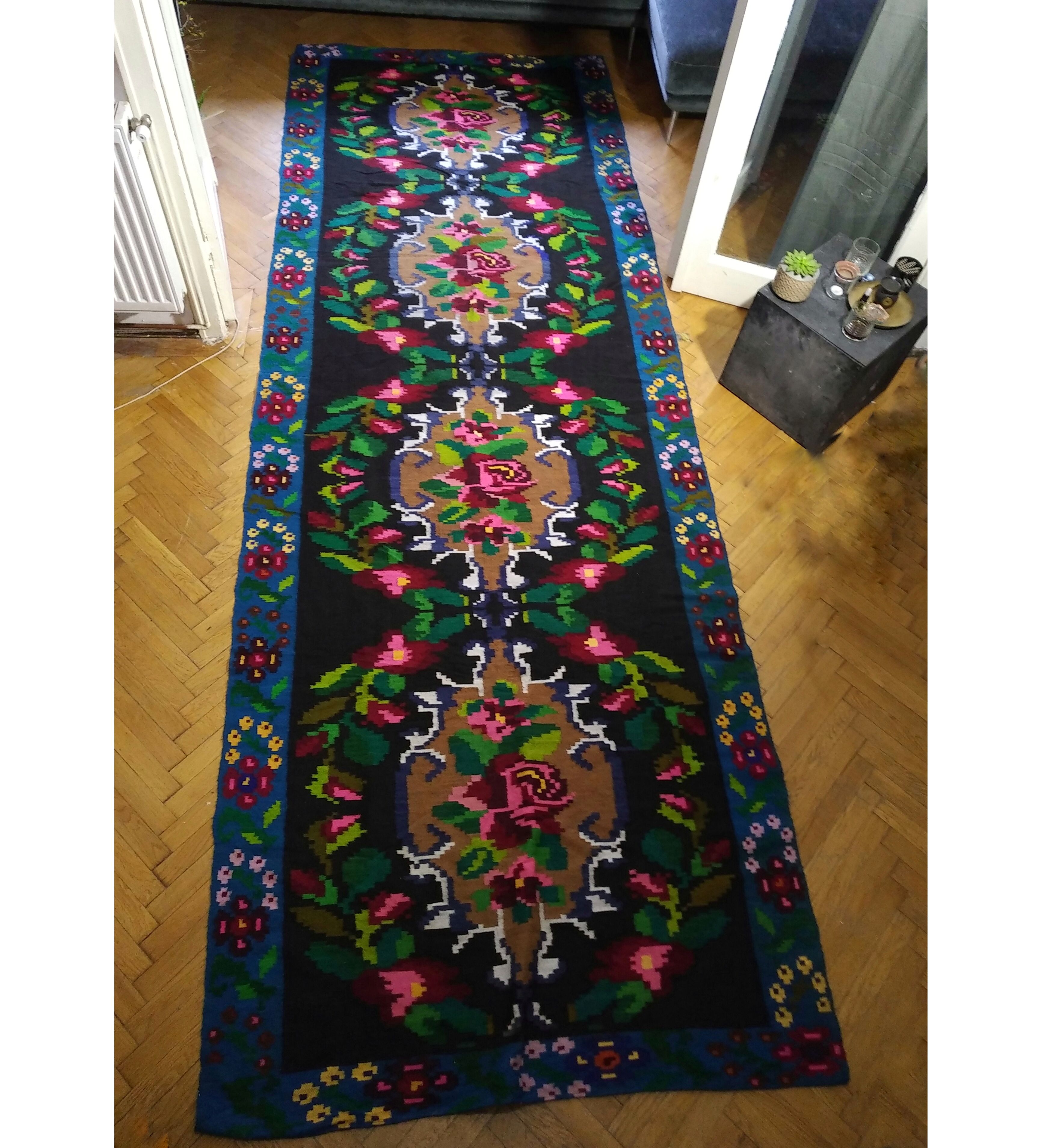 Romanian floral runner rug on blue background