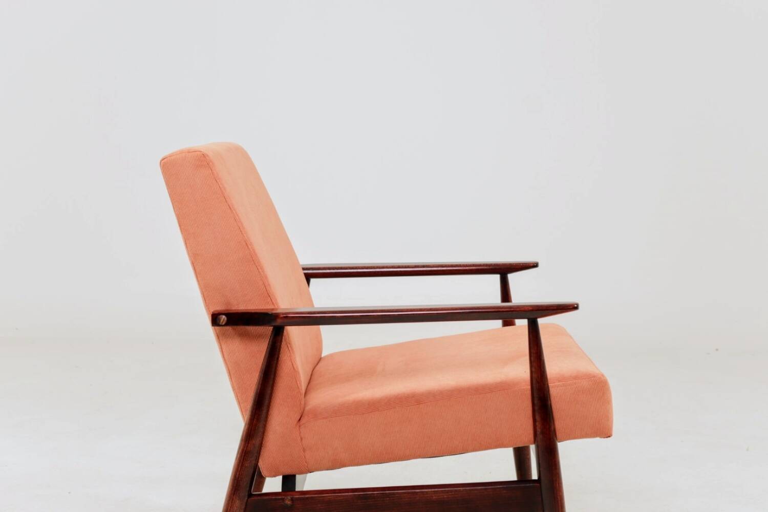 Mid-century modern armchair in coral red designed by H. Lis.