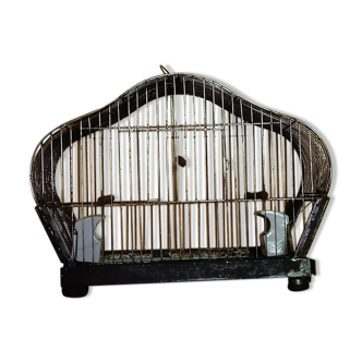 Metal bird cage with porcelain feeders.