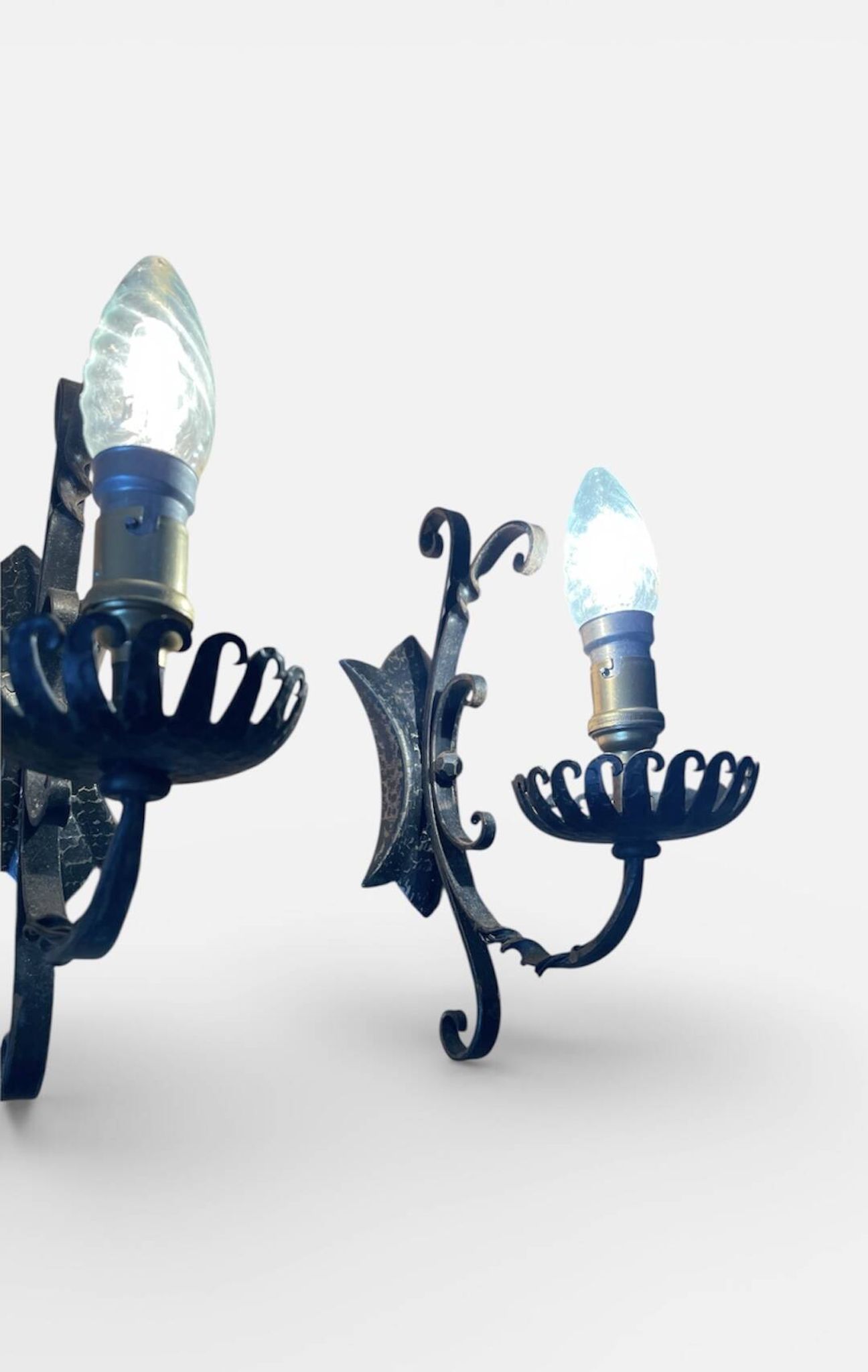 Vintage wrought iron wall lights in rustic gothic style.
