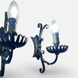 Vintage wrought iron wall lights in rustic gothic style.