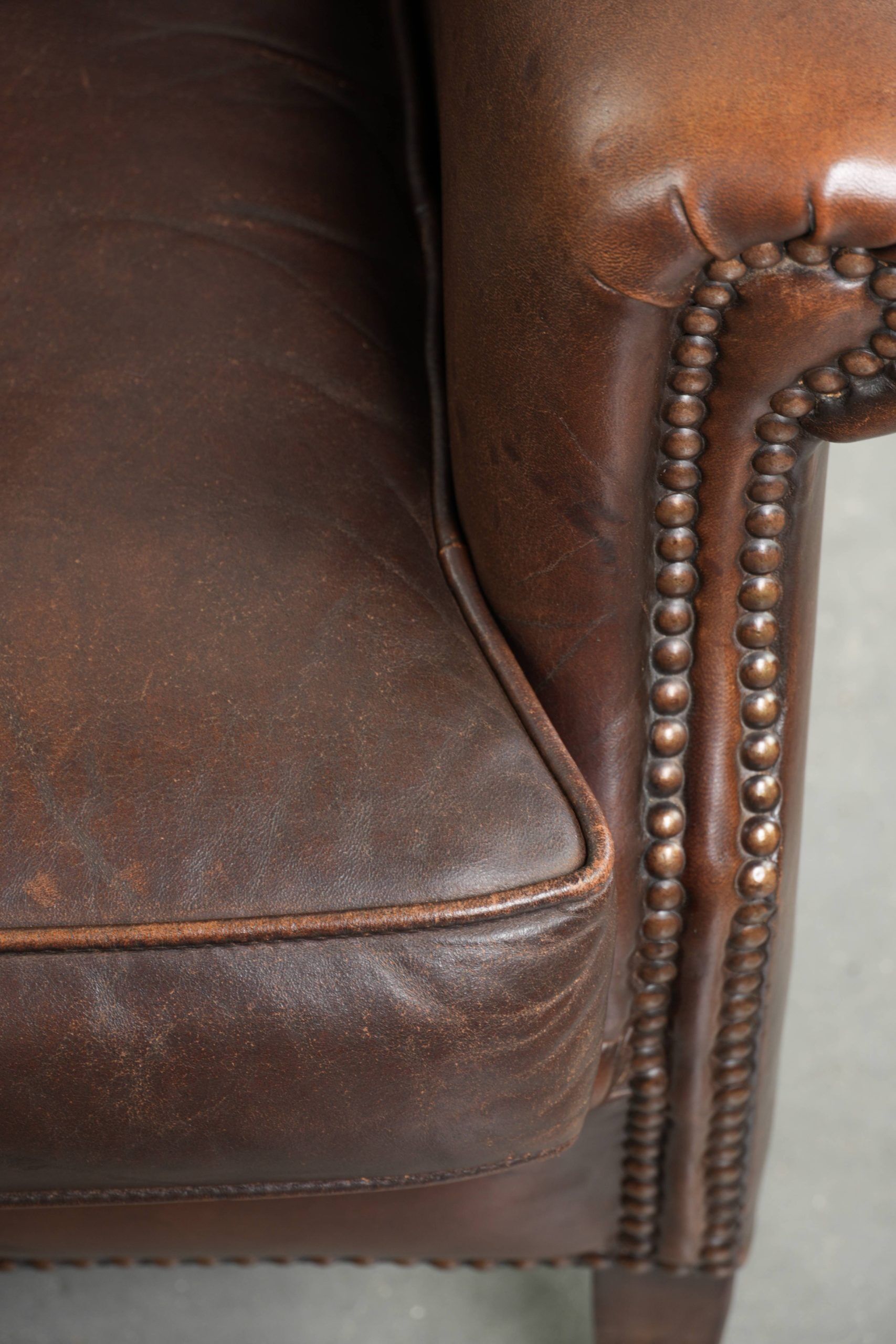 Subtle sheepskin wingback armchair with a deep cognac colour