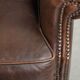 Subtle sheepskin wingback armchair with a deep cognac colour