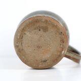 Handcrafted stoneware pitcher with blue-green hues, signed piece