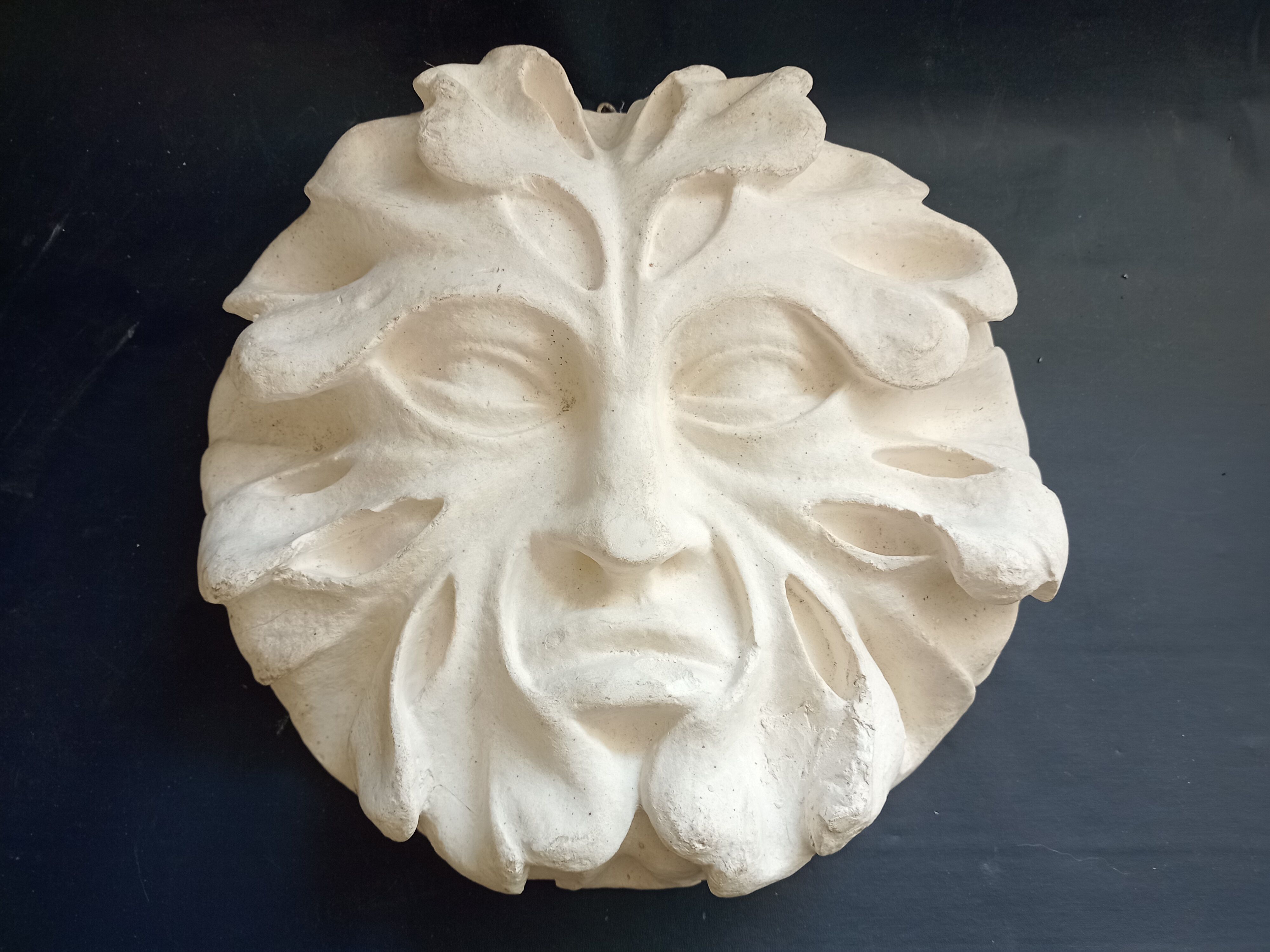 Bas relief sun in plaster