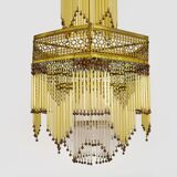 Art Nouveau style bronze chandelier with yellow and mauve pendants, 11 lights. 1960s