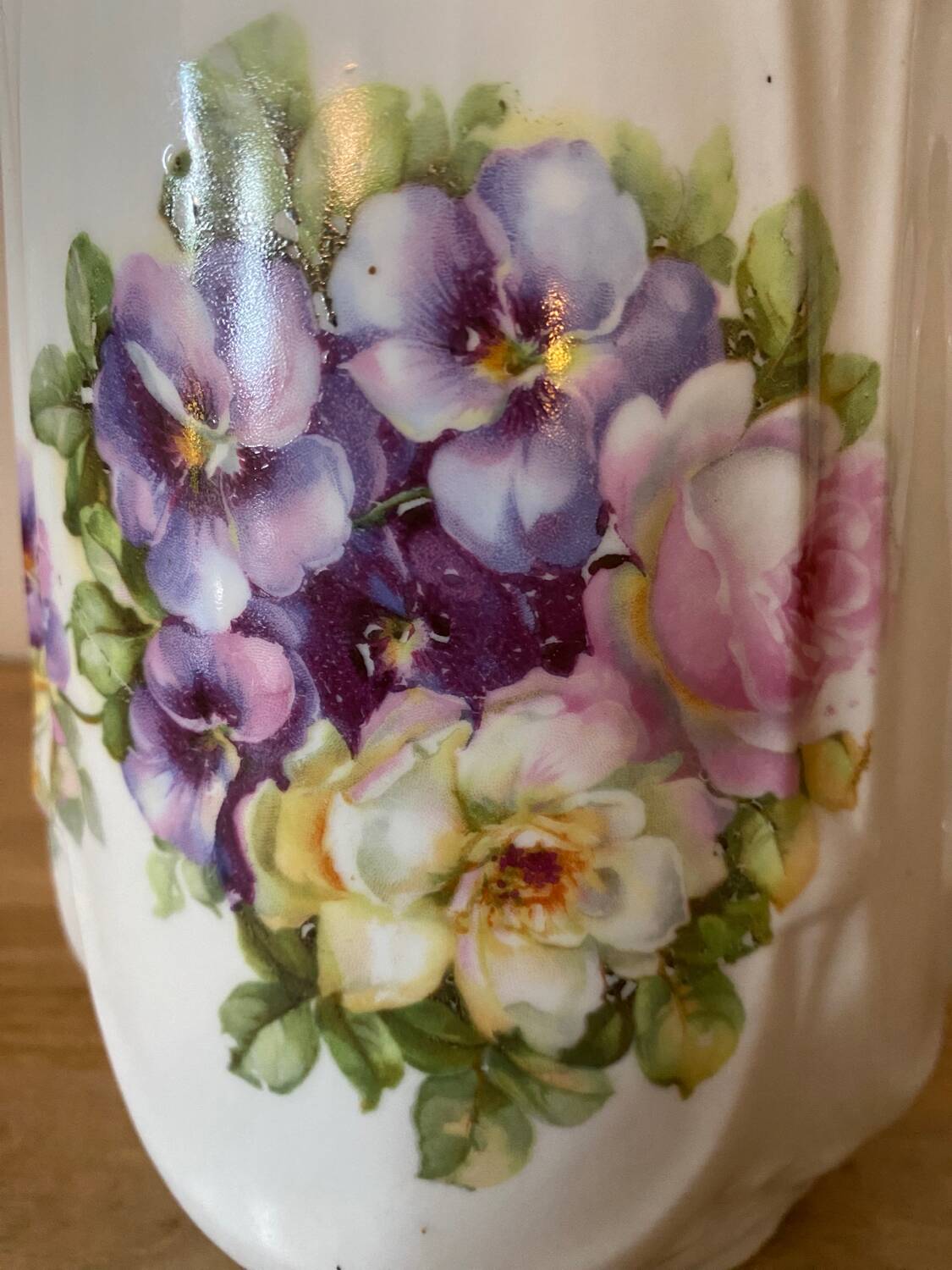 Old ceramic pitcher decorated with flowers