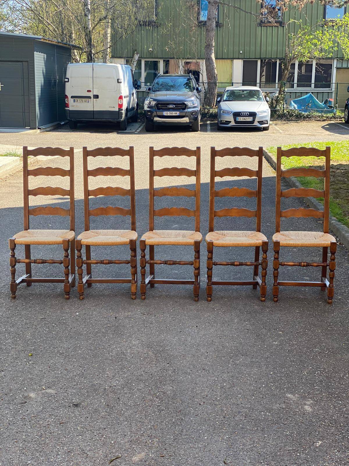 4 or 5 solid wood chairs with light oak straw and high backs