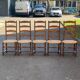 4 or 5 solid wood chairs with light oak straw and high backs