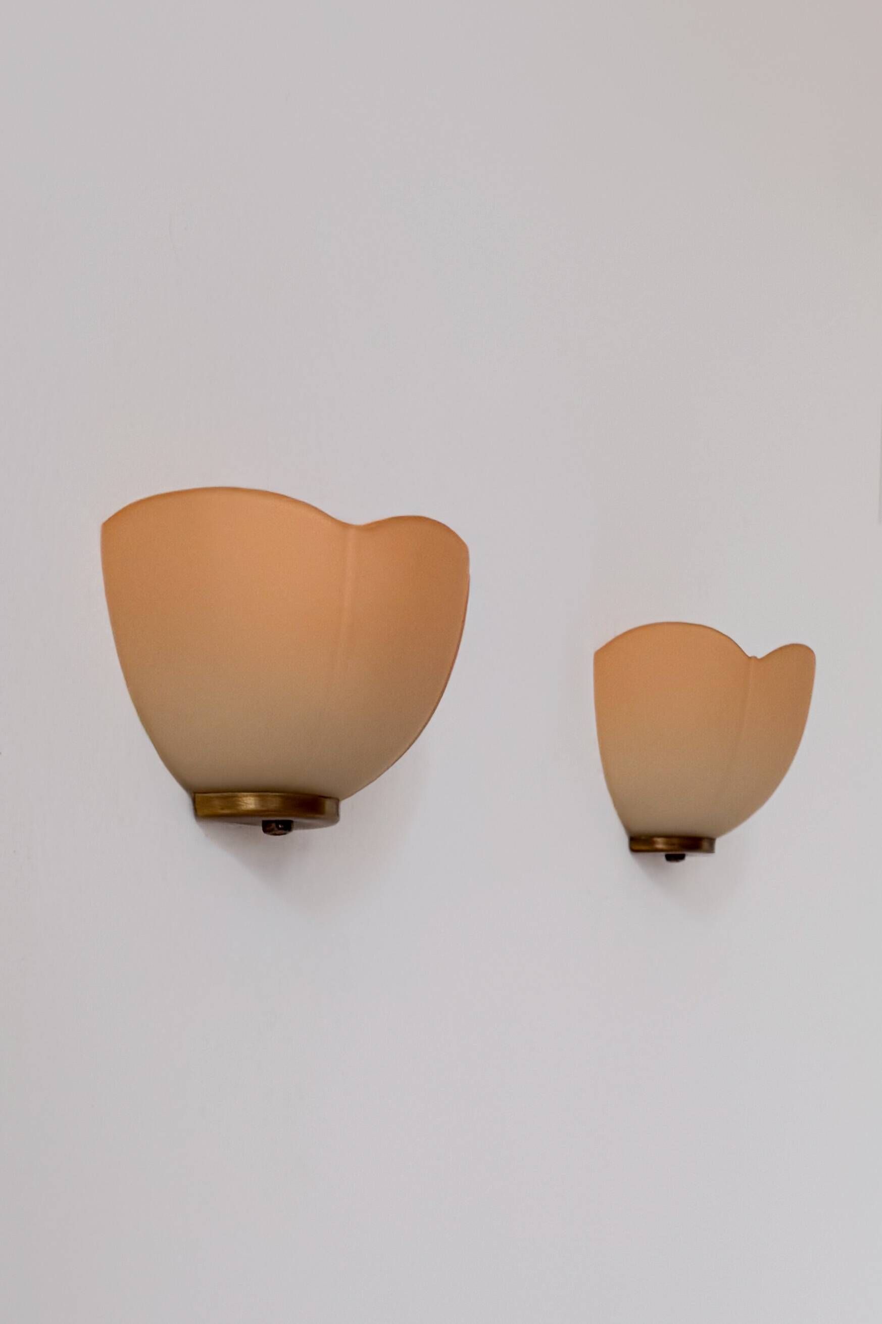 Vintage brass and orange glass wall sconces, France 1970.