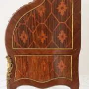 Louis XV cylinder desk with floral marquetry and gilded ornaments.