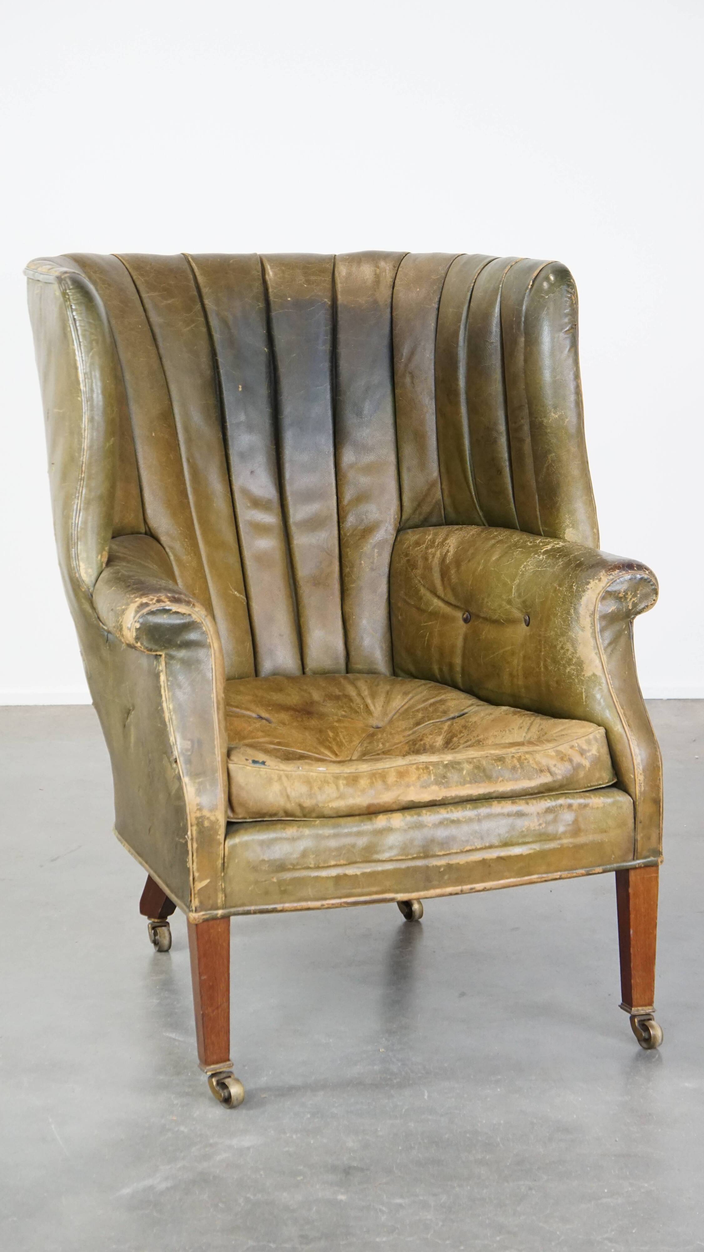 Green antique barrel back wingback chair on wheels