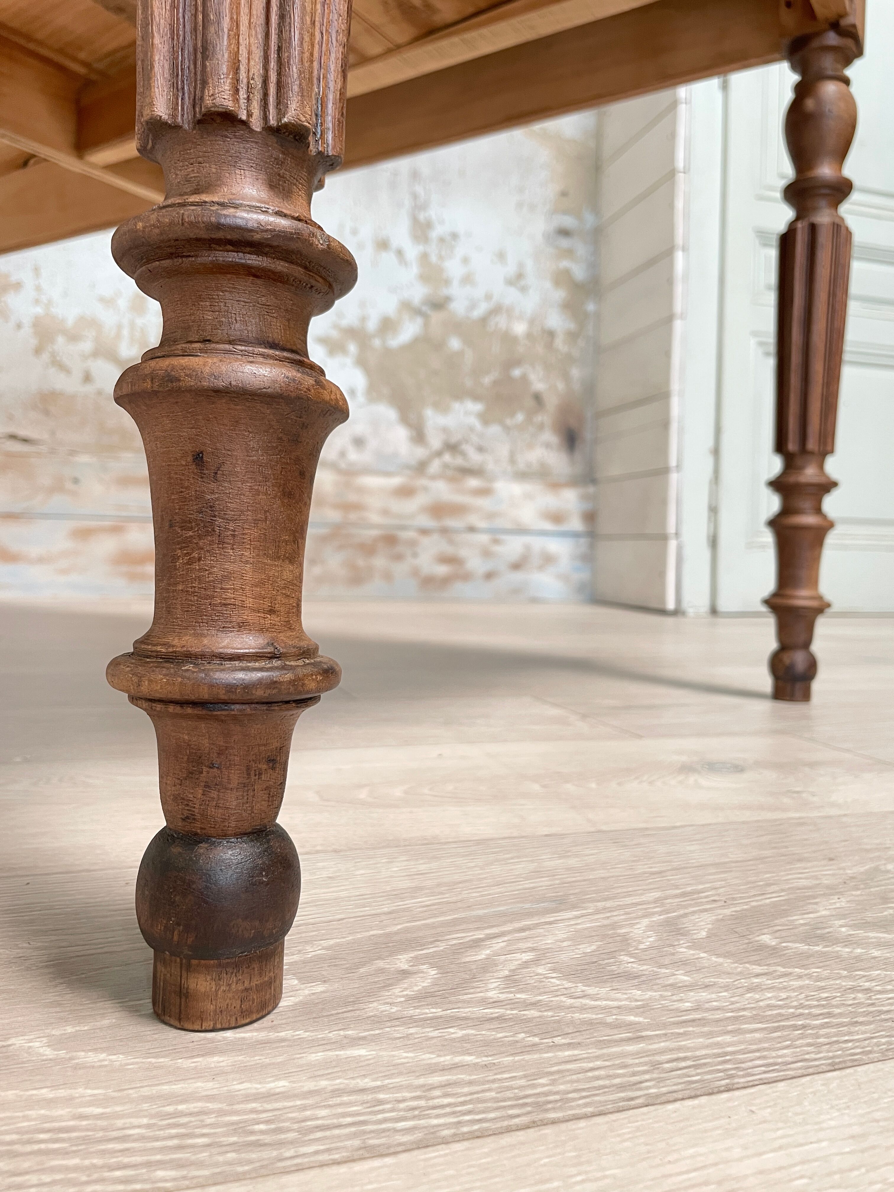 Vintage farmhouse table with turned legs.