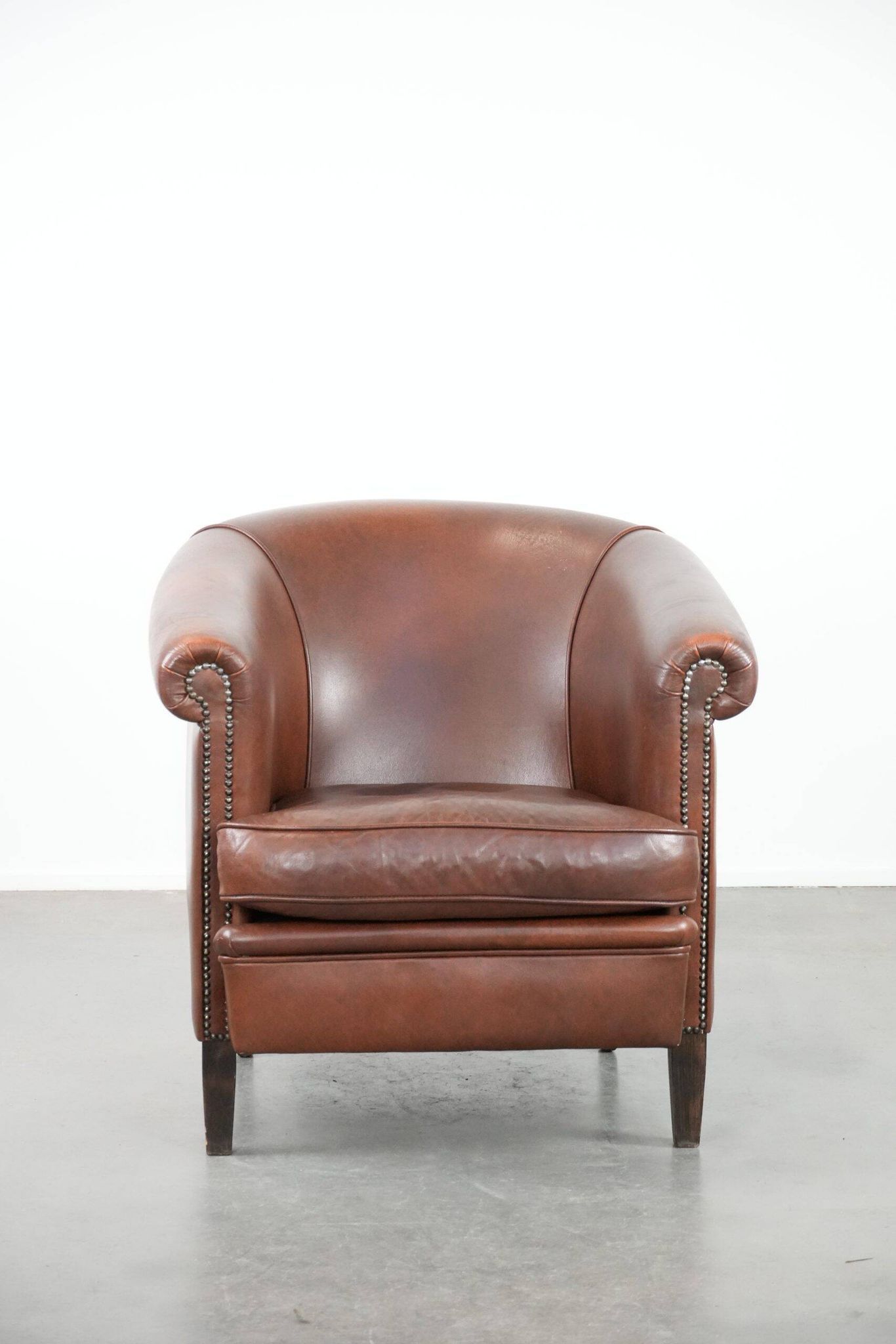 Cognac-coloured cow leather club armchair in English style