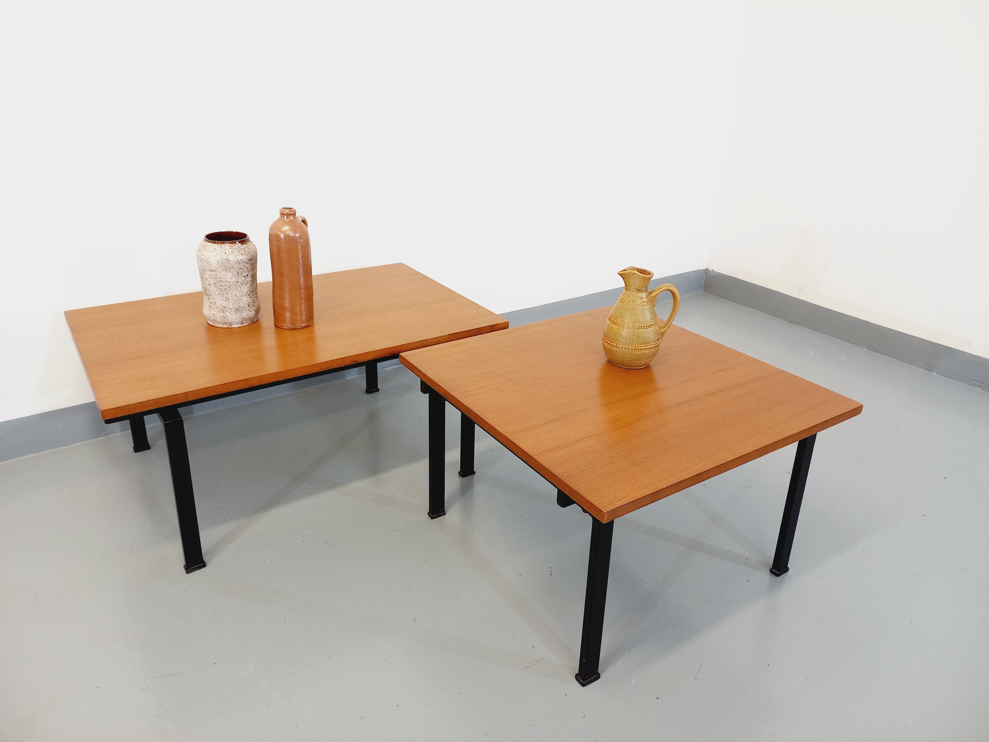 Suite of two vintage modernist Isa coffee tables in teak and black metal from the 60s