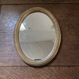 Classic oval mirror in gilded wood.