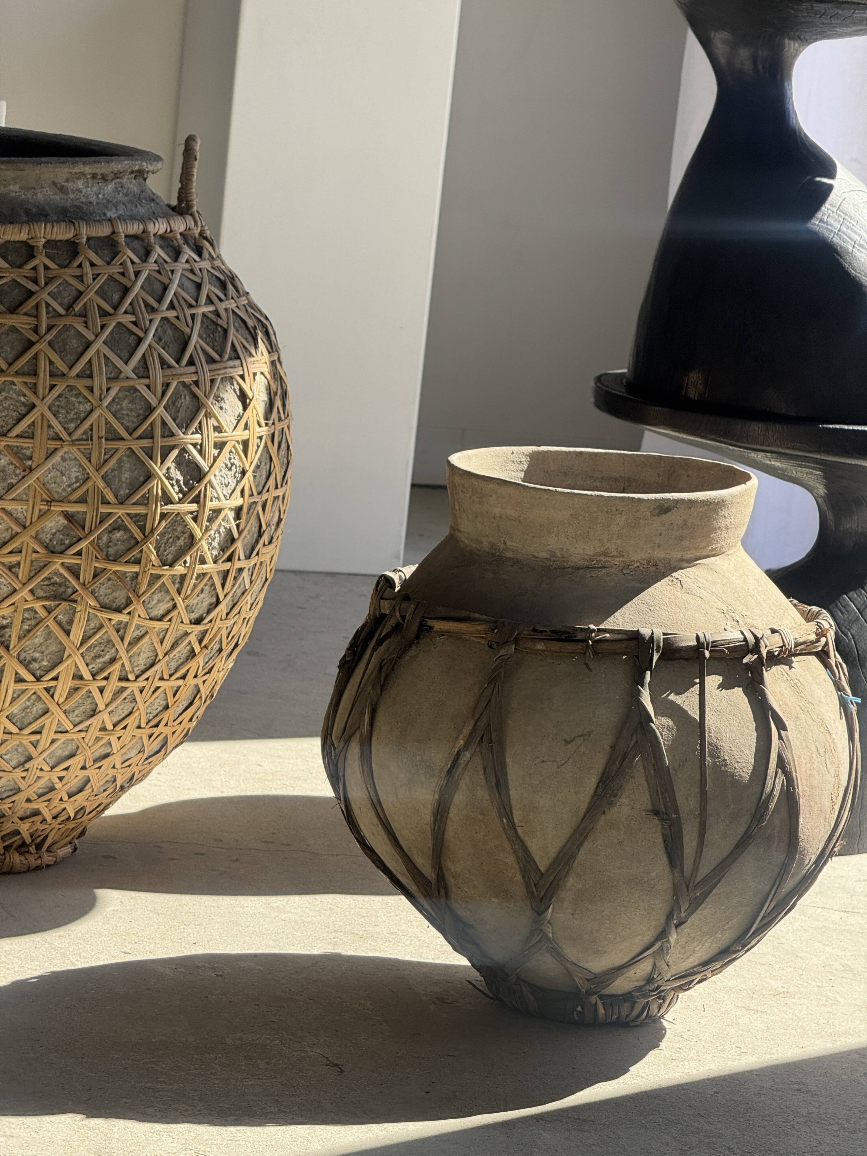 Immense light grey antique-style pot with a crosshatch lid and handles.