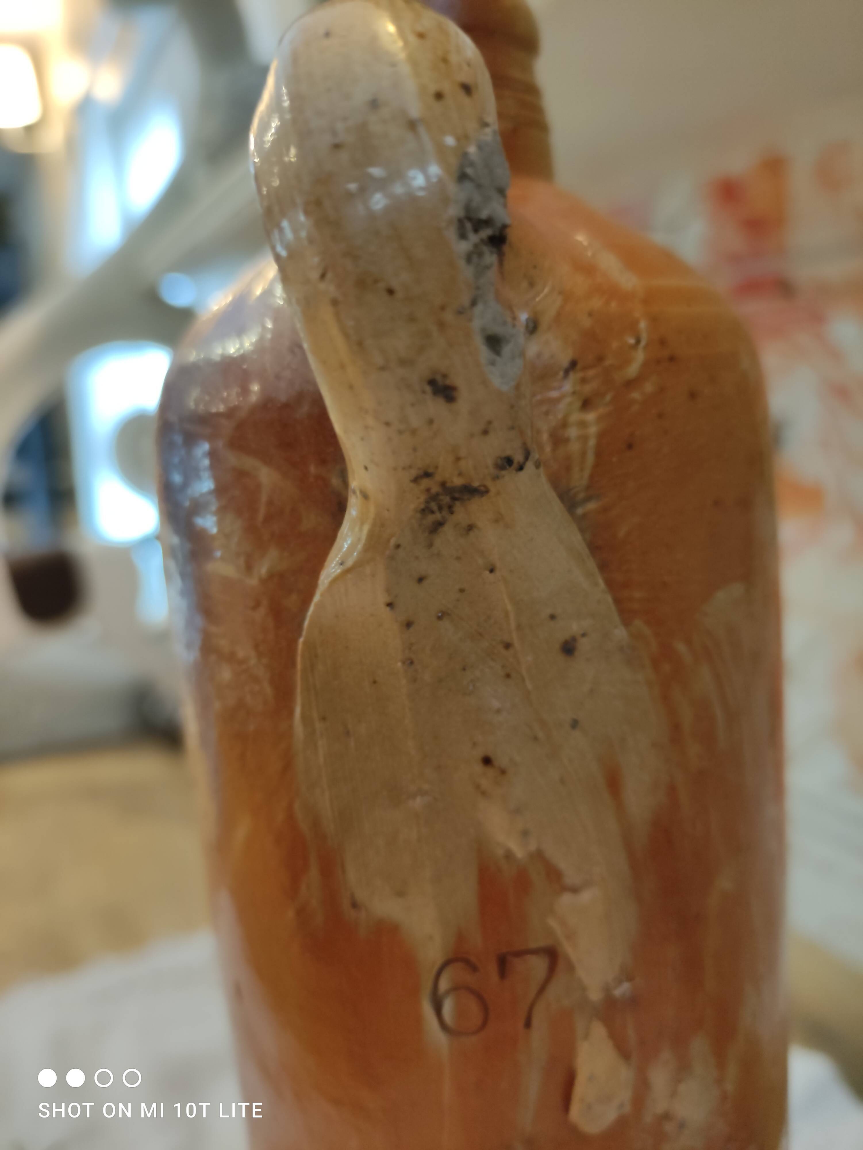 Old bottle in terracotta varnished finish