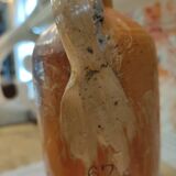 Old bottle in terracotta varnished finish