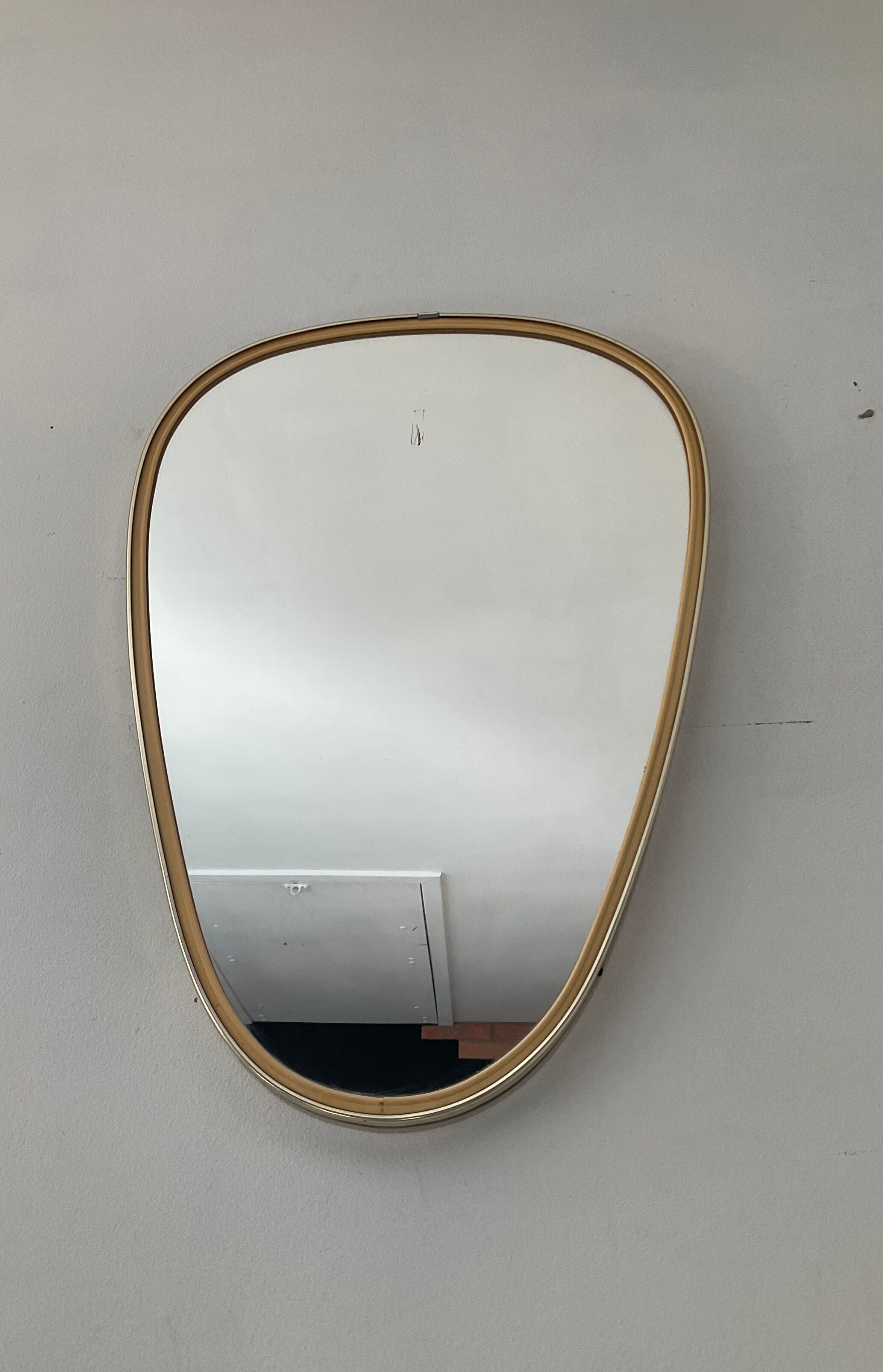 Free-form asymmetrical mirror from the 60s and 70s