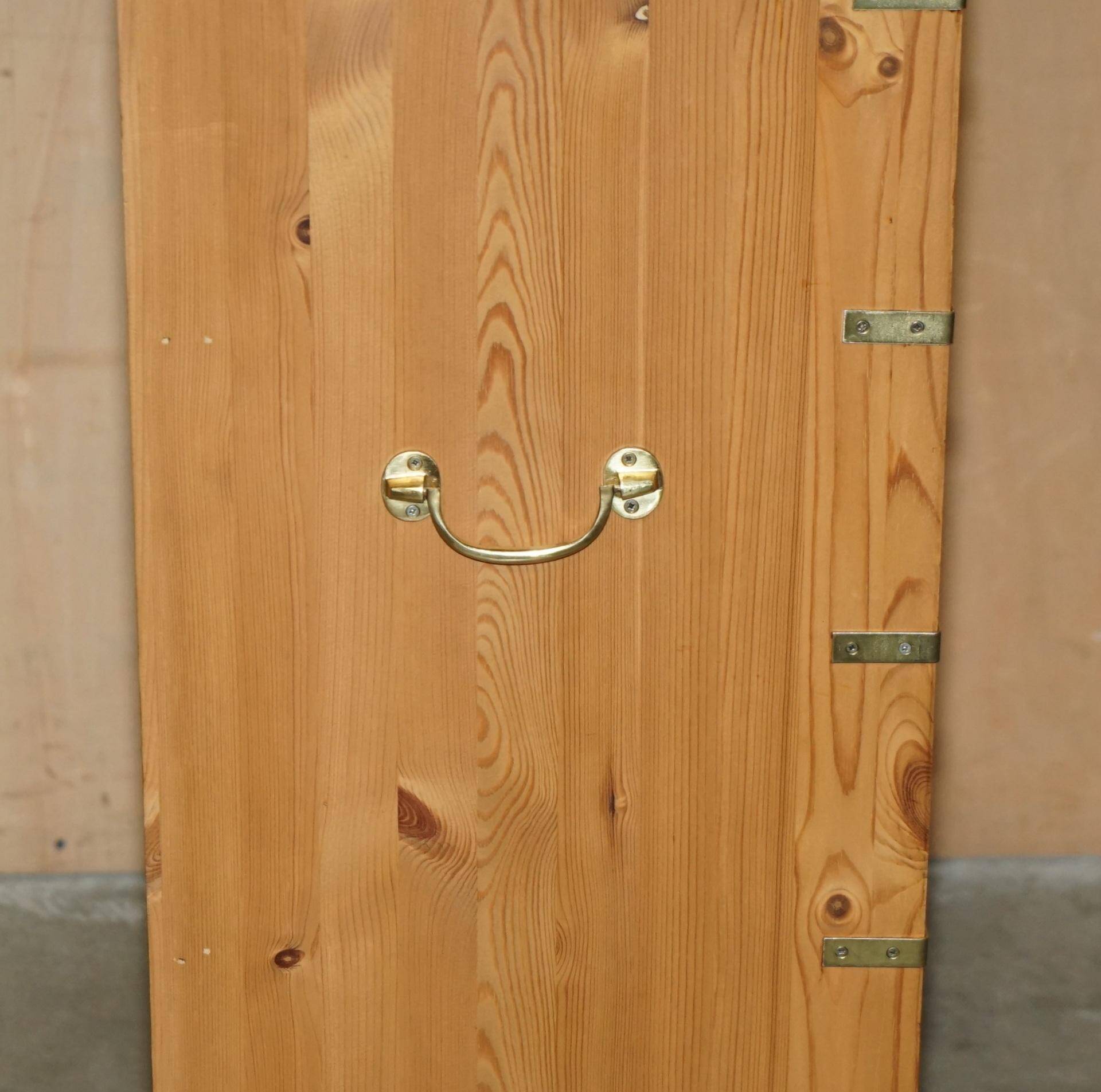 Restored vintage military high chest of drawers in English pine and brass.