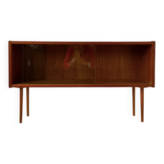 Low wooden cabinet with glass sliding doors.