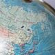 Luminous world map in tripod glass