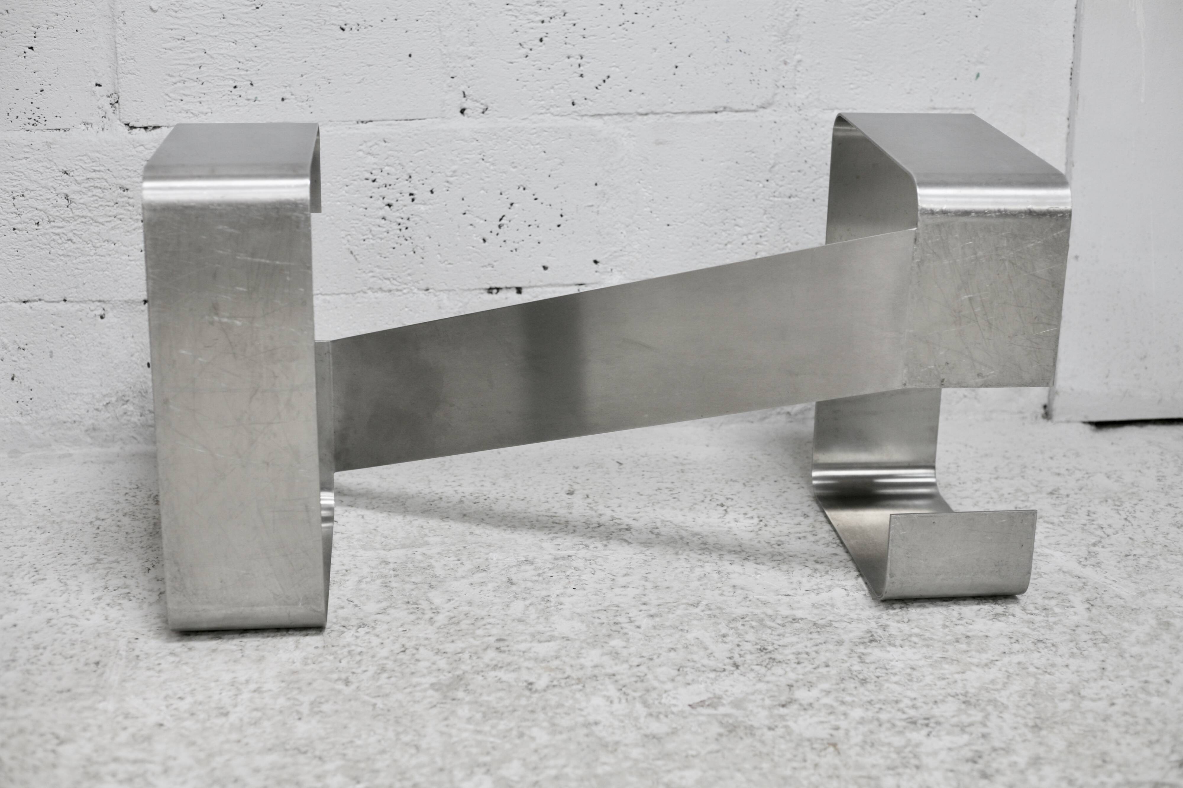 Coffee table with "kinetic" steel base and glass slab. Circa 1970.
