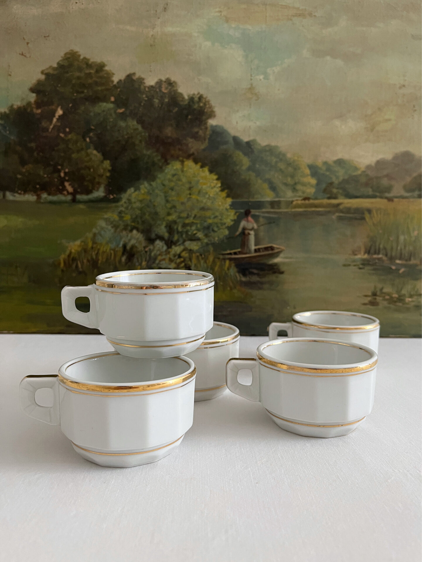 5 vintage porcelain bistro coffee cups from Paris with gold trim.