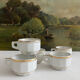5 vintage porcelain bistro coffee cups from Paris with gold trim.
