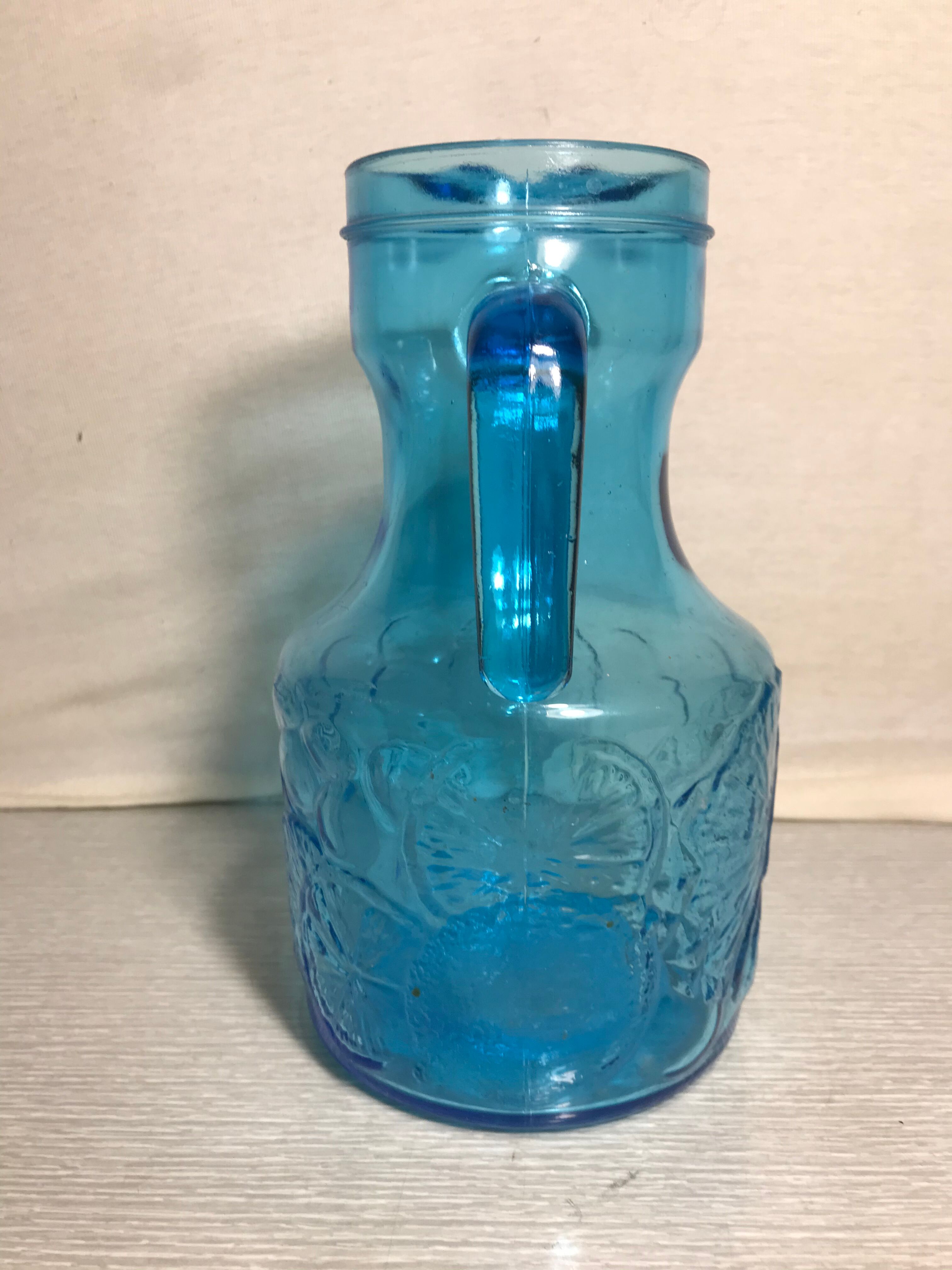 Blue moulded pitcher with decorative handle