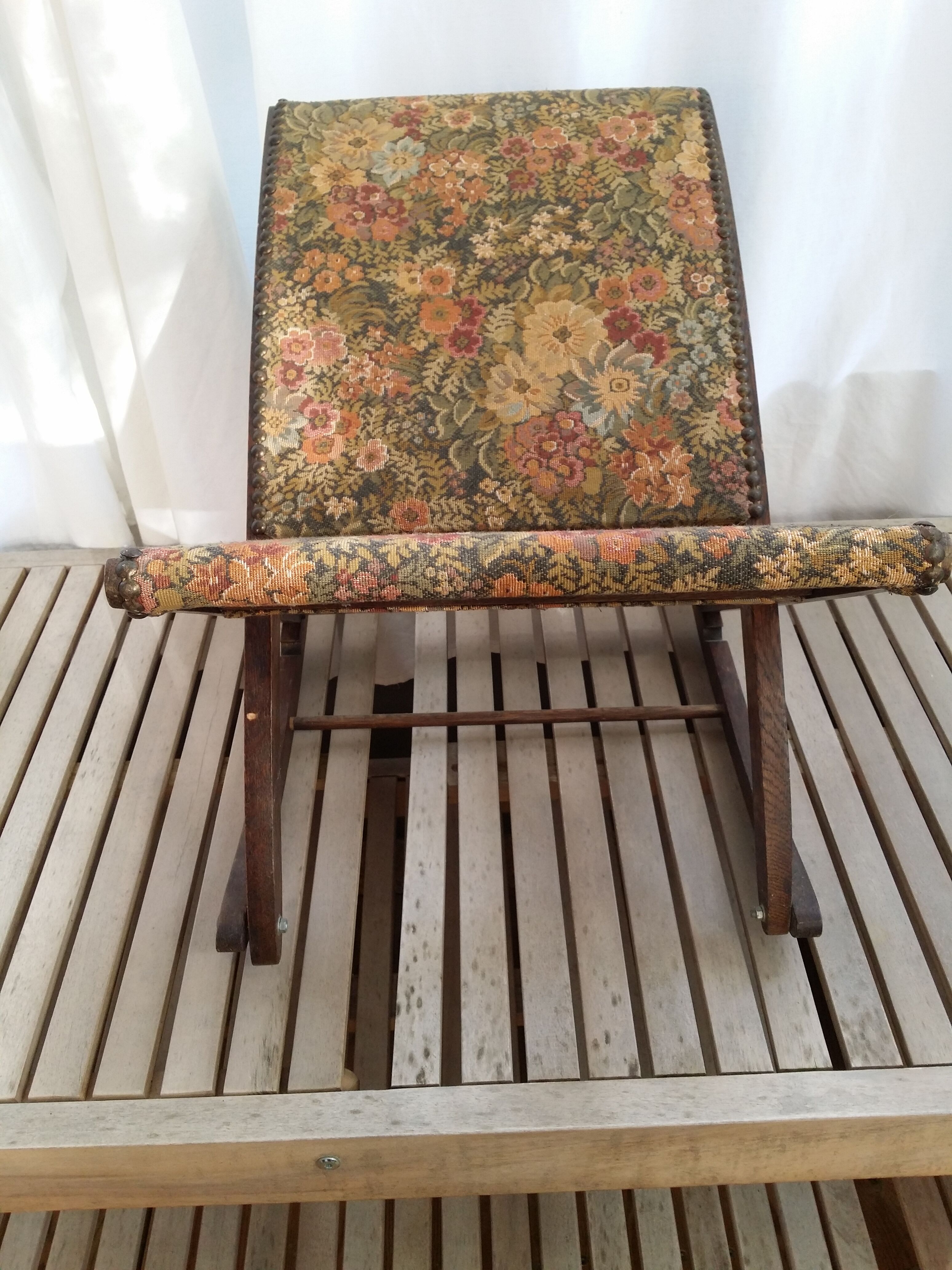 Wooden footrest and vintage tapestry
