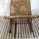Wooden footrest and vintage tapestry
