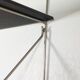 Mid-century vintage shelf in a loop shape, black glass and metal.