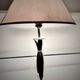 Contemporary table lamp in polished chrome with a conical fabric shade.