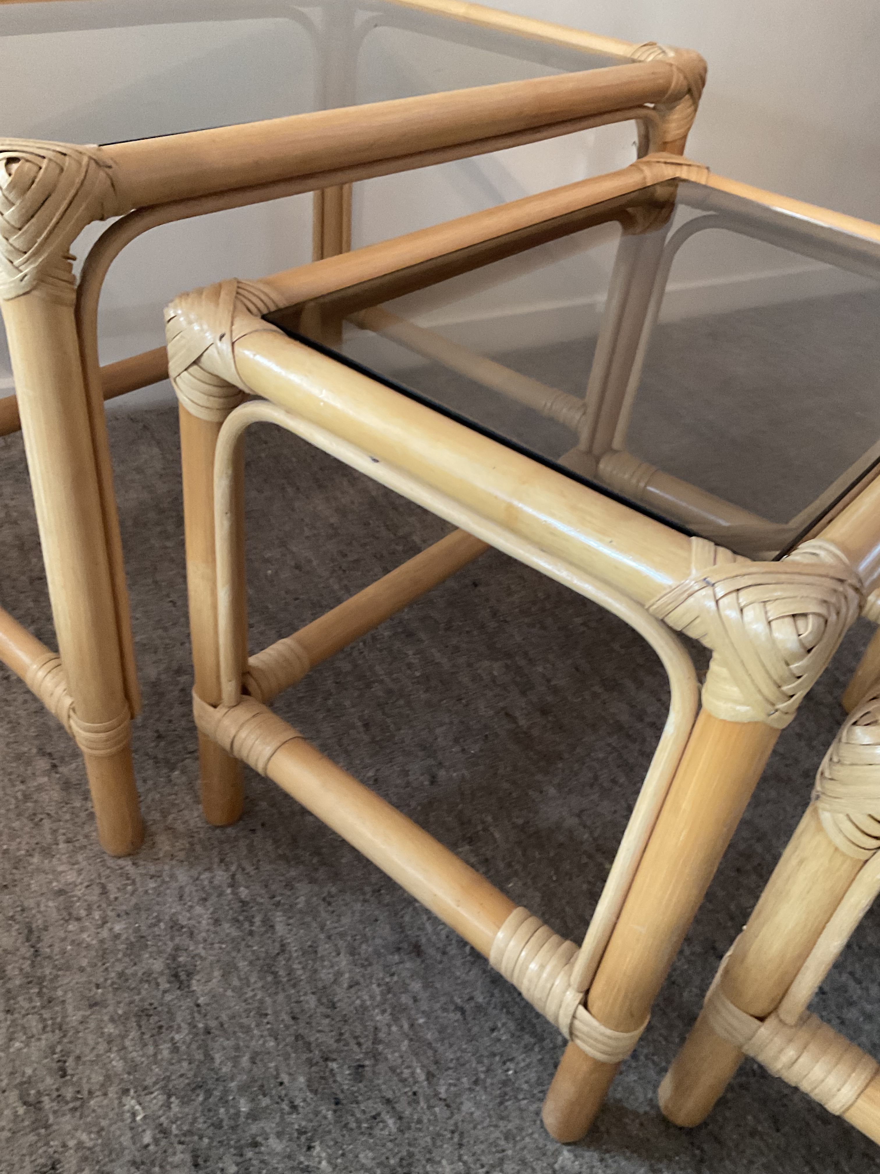 Trio of vintage pull-out tables in rattan and smoked glass 70s
