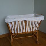 Rattan wicker cradle on wooden wheels