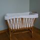 Rattan wicker cradle on wooden wheels